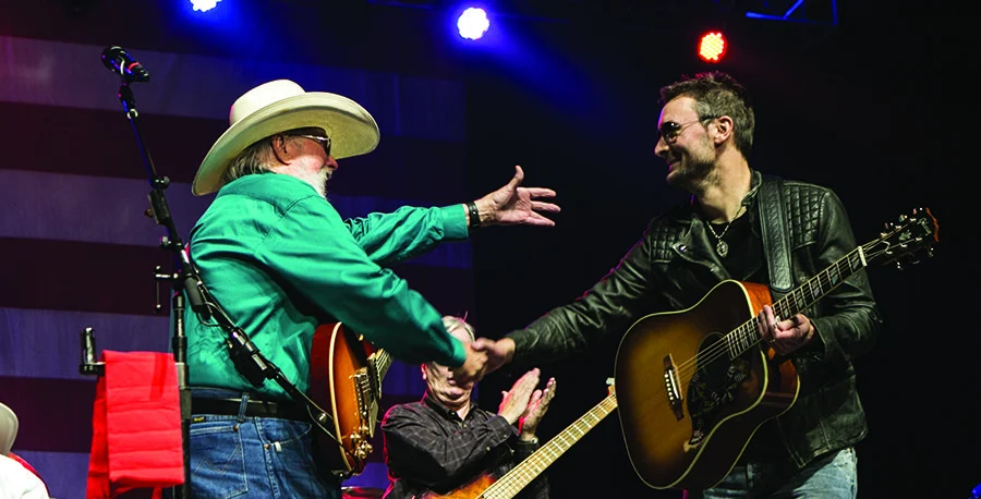 Country singer Charlie Daniels playing guitar with Eric Church on stage