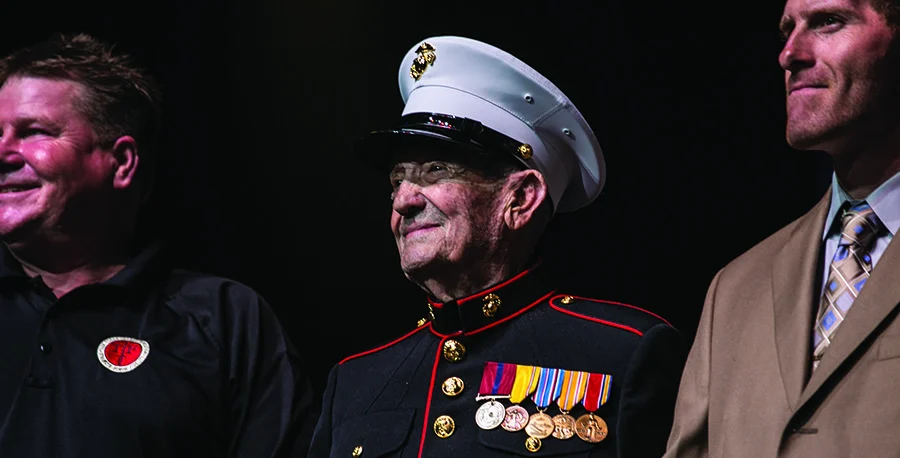 Event honoring military veterans with customized rifles on stage