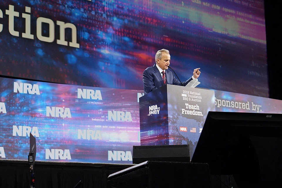 Man presenting Henry firearms at NRA Foundation Banquet