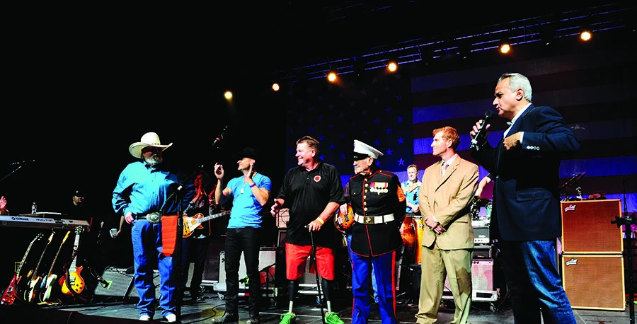 Henry Repeating Arms executives gifting commemorative rifles to military veterans at charity event