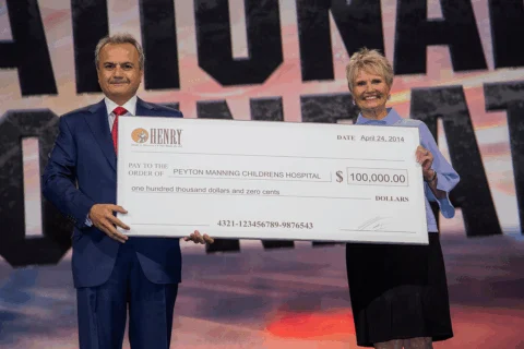 Henry Repeating Arms President Anthony Imperato presents $100,000 check to support Peyton Manning Children's Hospital