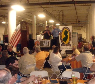 NRA banquet event hosted by Henry Repeating Arms, showing crowd of attendees and company banner