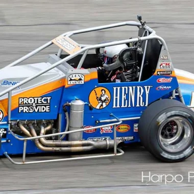 Henry Repeating Arms branded race car with orange and blue colors, white frame, and racing decals and sponsorships