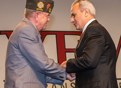 Henry Repeating Arms president presenting VFW commander-in-chief with military service tribute rifle