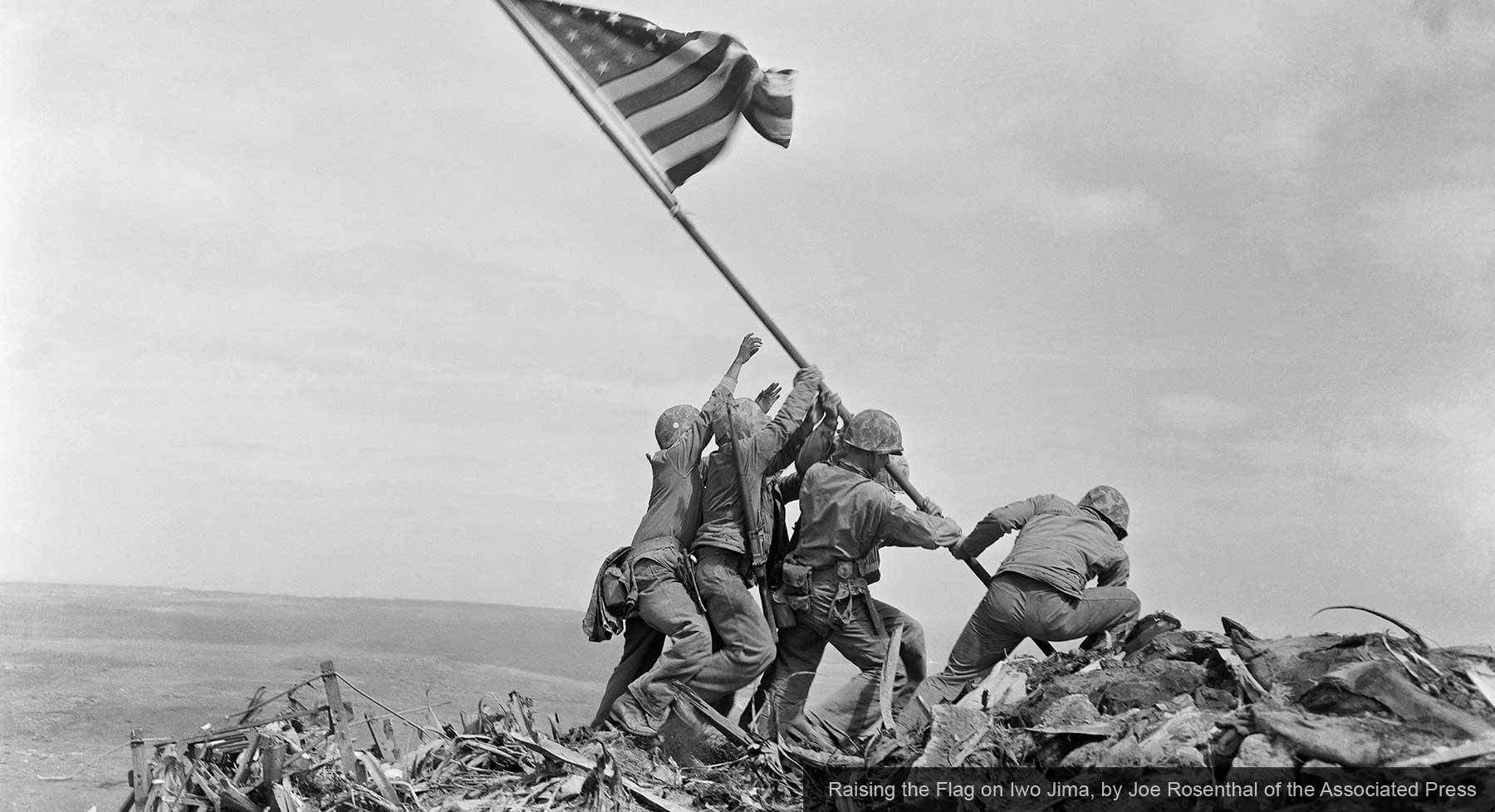 Iconic photograph of US Marines raising American flag on Iwo Jima during WWII battle