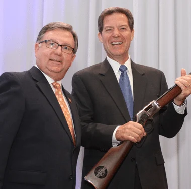 Kansas governor presented with Henry lever-action rifle at political event