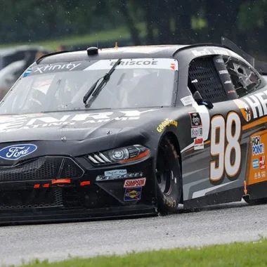 Ford stock car racing vehicle number 98 competing on a racetrack