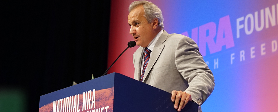 Henry Repeating Arms president presenting rifles on stage at the NRA Foundation Banquet