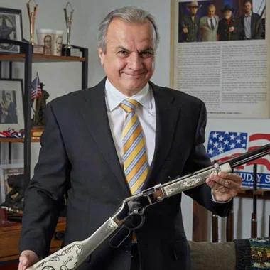 Portrait of Henry Repeating Arms president and owner Anthony Imperato, posing with a Henry lever-action rifle