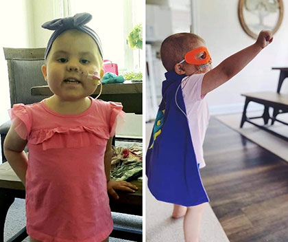 3-year-old girl Preslie Mantsch battling leukemia standing next to fire truck